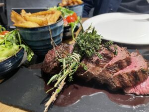 Savor the succulent flavors of our ox-grilled steak, perfectly complemented by a medley of fresh herbs, crisp salad, and golden triple-cooked chips. A tantalizing feast awaits at The Dartmoor Inn Merrivale.
